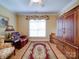 Cozy bedroom with hardwood floors, sitting area, and an armoire at 805 Stack Rd, Monroe, NC 28112