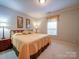 Bedroom with neutral tones, carpeted floors, and a comfortable bed at 805 Stack Rd, Monroe, NC 28112