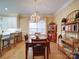 Charming dining room with wooden table and chairs, chandelier, and natural light from the window at 805 Stack Rd, Monroe, NC 28112