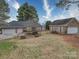 Beautiful brick home features a three car garage, manicured yard, and mature trees at 805 Stack Rd, Monroe, NC 28112