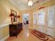 Inviting foyer with gleaming hardwood floors and a decorative accent chest at 805 Stack Rd, Monroe, NC 28112