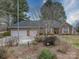 Well-maintained brick home with a three-car garage, mature landscaping, and inviting entrance at 805 Stack Rd, Monroe, NC 28112