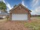 Close up of detached brick garage featuring a white door and a gable roof detail at 805 Stack Rd, Monroe, NC 28112