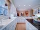 Bright kitchen features white cabinetry, island with black countertop, and an open design leading to the dining area at 805 Stack Rd, Monroe, NC 28112