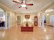 Bright living room featuring hardwood floors, a ceiling fan, and elegant architectural columns at 805 Stack Rd, Monroe, NC 28112