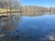 Scenic view of a serene pond reflecting the surrounding trees and sky at 805 Stack Rd, Monroe, NC 28112