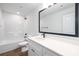 Well-lit bathroom with a single sink vanity, tub and shower combo, and modern fixtures at 8455 Old Plank Rd, Charlotte, NC 28216