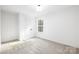 Bright bedroom with carpet, large window providing ample natural light, and closet at 8455 Old Plank Rd, Charlotte, NC 28216