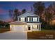 Charming two-story home with a well-maintained lawn and inviting entrance with beautiful architectural details at 8455 Old Plank Rd, Charlotte, NC 28216