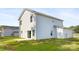 Backyard view of home showcasing well-maintained lawn and light gray siding at 8455 Old Plank Rd, Charlotte, NC 28216