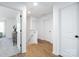 Hallway with hard wood flooring, a stair case, and multiple entrances to different rooms at 8455 Old Plank Rd, Charlotte, NC 28216