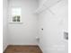 Functional laundry room with shelving, a window for natural light, and washer hookups at 8455 Old Plank Rd, Charlotte, NC 28216