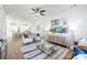 Bright, open living room with modern decor, ceiling fan, and an inviting view into the spacious kitchen at 8455 Old Plank Rd, Charlotte, NC 28216