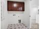 Laundry room with star-patterned flooring, dark cabinets, and washer/dryer hookups at 9495 Coast Laurel Nw Ave, Concord, NC 28027