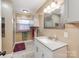 Bathroom with a modern vanity, updated mirror, and walk-in shower with grab bar at 9524 Fairlane Dr, Charlotte, NC 28214