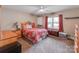 Cozy bedroom features a patterned bedspread, window with curtains, and neutral-toned walls at 9524 Fairlane Dr, Charlotte, NC 28214