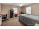 Simple bedroom featuring carpeted floors, multiple windows, a desk, and a safe at 9524 Fairlane Dr, Charlotte, NC 28214