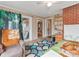 Bedroom with a ceiling fan, brick wall, and door to a sunroom at 9524 Fairlane Dr, Charlotte, NC 28214