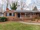 Inviting brick home with a cozy front porch, perfect for enjoying the outdoors at 9524 Fairlane Dr, Charlotte, NC 28214