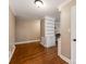 Hallway with hardwood floors, white trim, and built-in shelving at 9524 Fairlane Dr, Charlotte, NC 28214