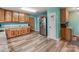 View of the kitchen with stainless steel refrigerator, wooden cabinets, and light countertops at 9524 Fairlane Dr, Charlotte, NC 28214