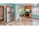 Bright kitchen with wood cabinets, stainless steel appliances, light countertops, and vinyl flooring at 9524 Fairlane Dr, Charlotte, NC 28214