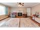 Cozy living room featuring hardwood floors, a fireplace, and ample natural light at 9524 Fairlane Dr, Charlotte, NC 28214