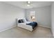 Cozy bedroom with neutral carpet, ceiling fan, and natural light from the window at 1102 Less Traveled Trl, Indian Trail, NC 28079