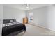 Neutral bedroom with a carpet, ceiling fan, and window for natural light at 1102 Less Traveled Trl, Indian Trail, NC 28079