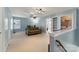 Spacious bonus room featuring neutral carpeting, a ceiling fan, and ample natural light at 1102 Less Traveled Trl, Indian Trail, NC 28079