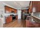 Well-lit kitchen featuring stainless steel appliances, granite countertops, and wooden cabinets at 1102 Less Traveled Trl, Indian Trail, NC 28079