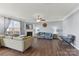 Cozy living room featuring a fireplace, plush sofas, hardwood floors, and neutral wall colors at 1102 Less Traveled Trl, Indian Trail, NC 28079