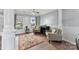 Comfortable living room with two patterned chairs, area rug and large windows at 1102 Less Traveled Trl, Indian Trail, NC 28079