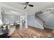 Elegant living room featuring hardwood floors, neutral wall colors, and staircase access to dining room at 1102 Less Traveled Trl, Indian Trail, NC 28079