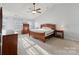 Bright main bedroom with vaulted ceiling, ceiling fan, natural light, and wood furniture at 1102 Less Traveled Trl, Indian Trail, NC 28079