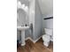 Updated powder room with pedestal sink, modern fixtures, and neutral color palette at 1102 Less Traveled Trl, Indian Trail, NC 28079