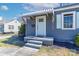 Charming front porch with a light blue door, white awning, and neat landscaping at 1205 Poston Cir, Gastonia, NC 28054