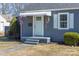 Charming front porch with a light blue door, white awning, and neat landscaping at 1205 Poston Cir, Gastonia, NC 28054