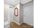 Hallway featuring wood-look floors, white doors, and a decorative mirror at 1205 Poston Cir, Gastonia, NC 28054