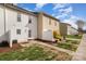 View of a townhouse backyard with grass and patio at 128 Locomotive Ln # 110, Mooresville, NC 28115