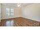 Spacious bedroom with a ceiling fan, hardwood floors, and natural light at 128 Locomotive Ln # 110, Mooresville, NC 28115