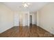 Spacious bedroom featuring hardwood floors, neutral walls, and ensuite at 128 Locomotive Ln # 110, Mooresville, NC 28115