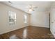 This bedroom features wood floors, neutral walls, and a ceiling fan at 128 Locomotive Ln # 110, Mooresville, NC 28115