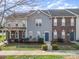 Charming townhomes featuring colorful siding, brick accents and manicured landscaping at 128 Locomotive Ln # 110, Mooresville, NC 28115