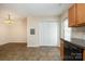 Open kitchen and dining area featuring tile flooring, natural light, and pantry at 128 Locomotive Ln # 110, Mooresville, NC 28115