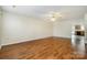 Spacious living room featuring hardwood floors, ceiling fan, and natural light at 128 Locomotive Ln # 110, Mooresville, NC 28115