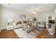 Bright living room featuring hardwood floors, neutral paint, a ceiling fan and updated stylish furniture at 128 Locomotive Ln # 110, Mooresville, NC 28115