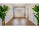 Charming dining room with wainscoting, picture windows, and a modern chandelier at 14705 Superior St, Charlotte, NC 28273