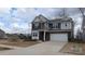 Attractive two-story home featuring a mixed facade, well-manicured lawn, and a two-car garage at 14705 Superior St, Charlotte, NC 28273