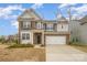 Charming two-story home with brick and gray siding, a two-car garage, and landscaped front yard at 14705 Superior St, Charlotte, NC 28273